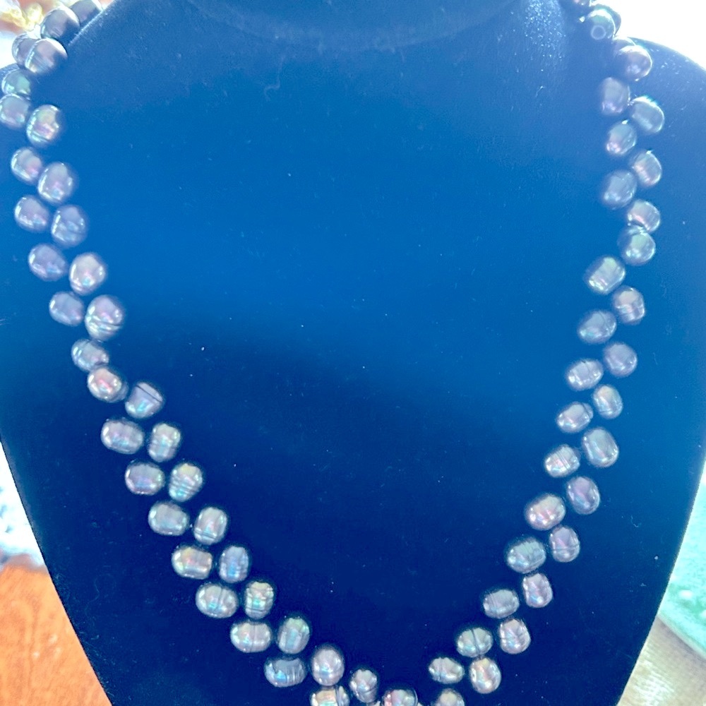 Genuine freshwater pearls, single strand knotted with silver claw clasp